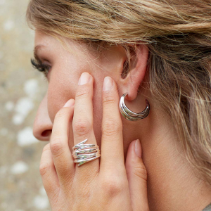 Model wearing Helix Wrap Grande Ring by British sterling silver jewellery designer Kit Heath