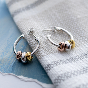 Coast Tumble Golden Hoop Earrings stylised image — The Coast collection 